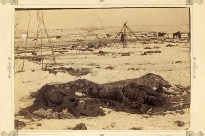December 29. Caption: Big Foot’s camp three weeks after the Wounded Knee Massacre (Dec. 29, 1890), with bodies of several Lakota Sioux people wrapped in blankets in the foreground and U.S. soldiers in the background.  Credit: National Archives