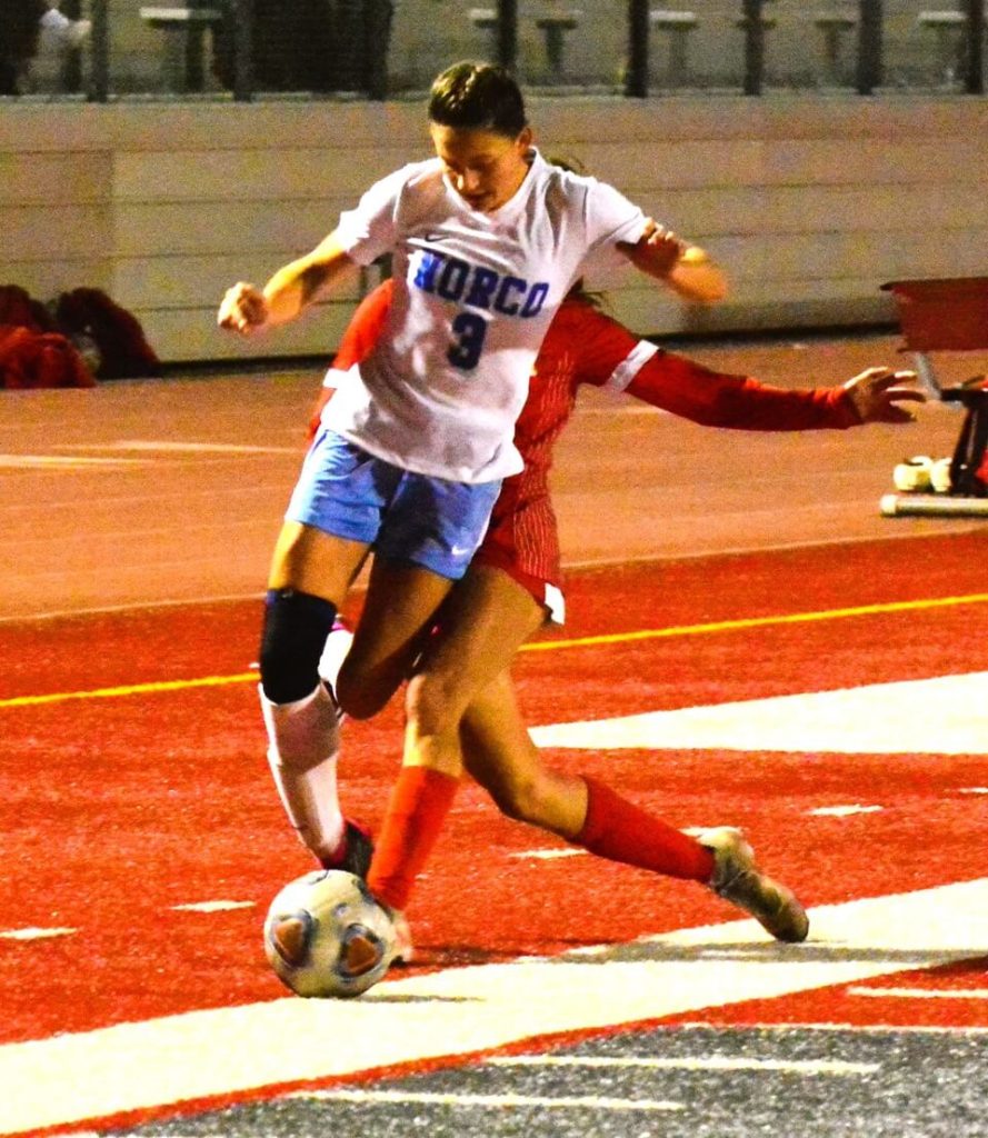 Norco’s Karen Pedraza (3) is taken down by a hard slide tackle by Corona’s Alannah Noriega (20) during the Cougars 2 – 0 win over the Panthers 2 – 0. Credit: Photo by Gary Evans