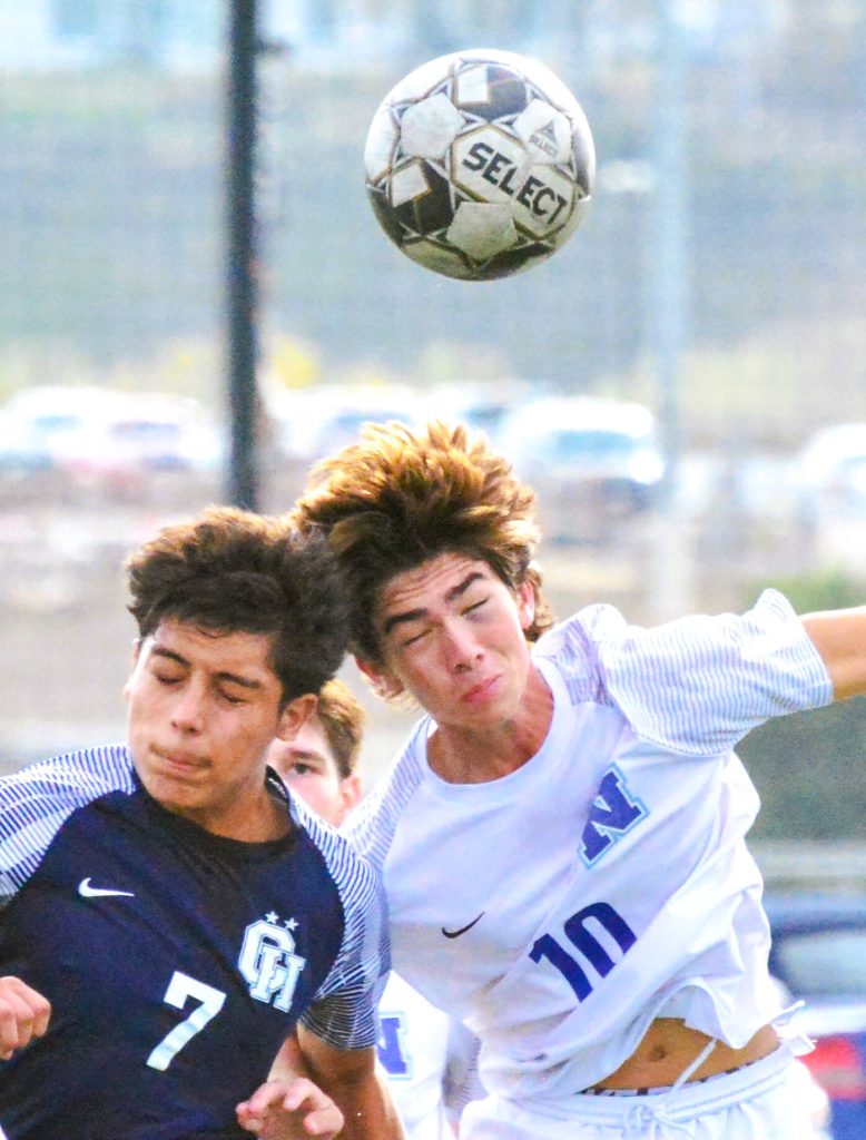 Citrus Hill’s Isaac Huerta (7) and Norco’s Brady Wagner (10) grimace trying for a header during the Cougars 2 – 0 Winter Classic Soccer Tournament victory over the Hawks.