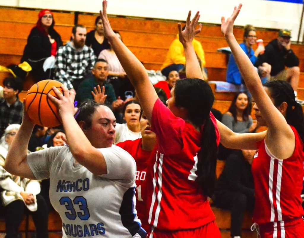 Norco’s Evalen Garica-Meza (33) is surrounded by Corona’s Gabriela Castro (1), Ava Liaga (12) and Gizelle Acosta (4) during the Panthers 59 – 32 victory over the Cougars. Photo by Gary Evans