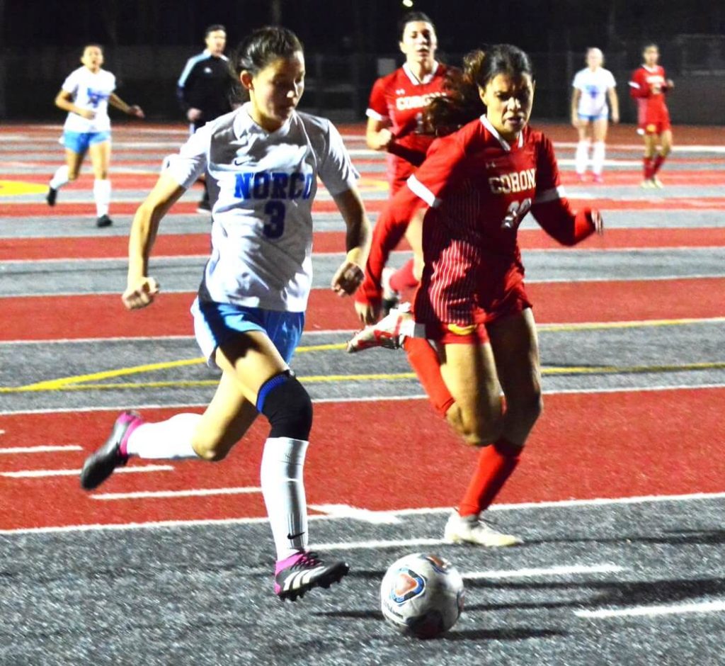 Norco’s Emmalee Snow (3) is ready to take a shot on goal while Corona’s Alannah Noriega (20) tries to cut Snow off. The Cougars defeated the Panthers 2 – 0. Credit: Photo by Gary Evans