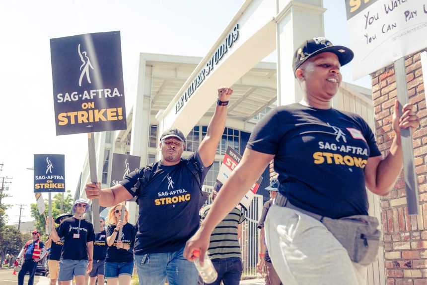 Screen Actors Guild members and Writers Guild of America members picket at the Amazon Culver Studios in Culver City on June 17, 2023. A bill would pay strikers unemployment benefits.  Credit: Photo by Julie A Hotz for CalMatters