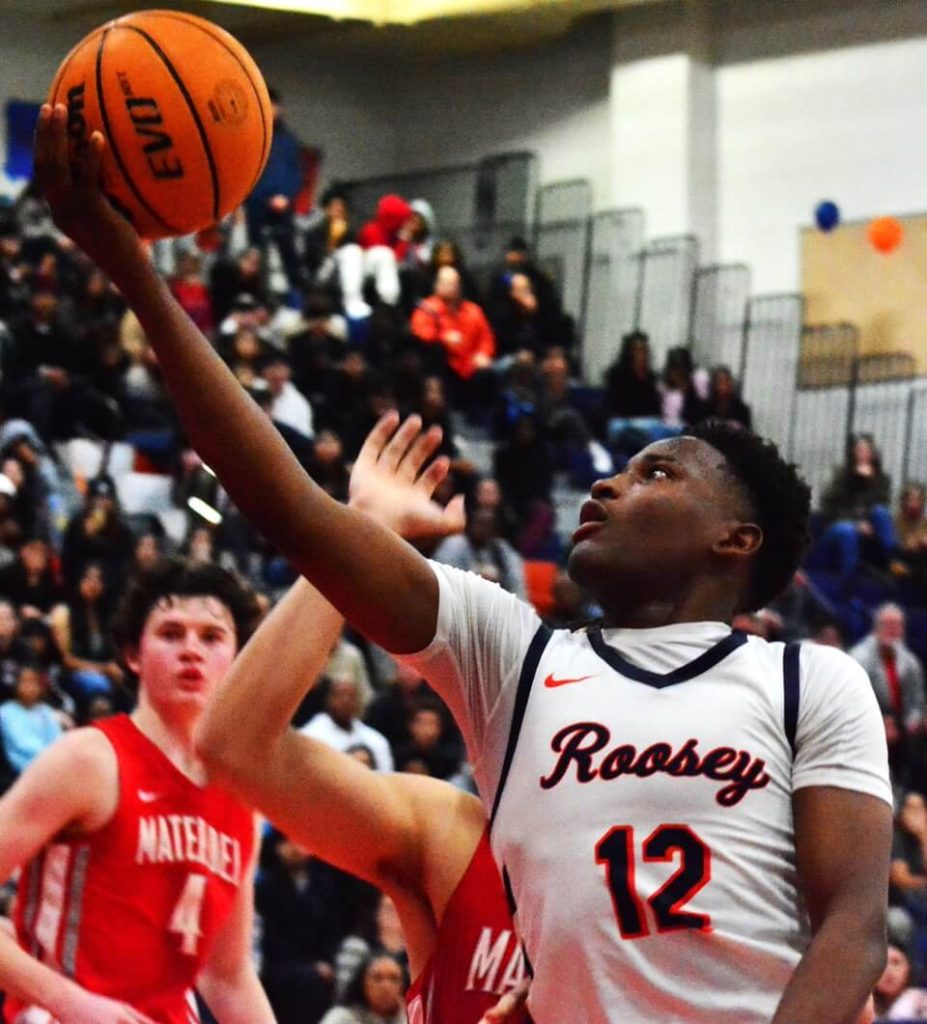 Eastvale Roosevelt’s Issac Williamson (12) drives for a score against Mater Dei during the overtime period of their Open Division playoff game.  The Mustangs defeated the Monarchs 80 – 76 winning all three games in pool play,  advancing to tonight's championship game vs Studio City Harvard-Westlake. 
Credit: Photo by Gary Evans
