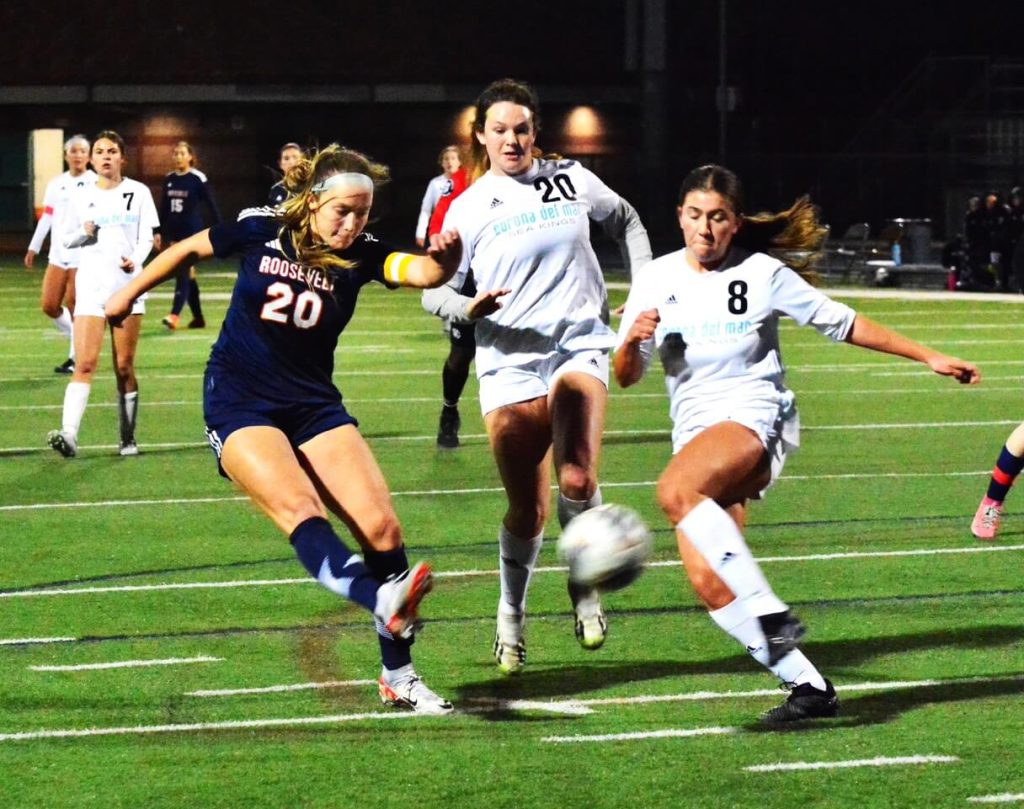 Eastvale Roosevelt’s Mia Goettsche (20) blasts a shot on goal against Corona Del Mar during the Mustangs 2 – 0 CIF playoff victory over the Sea Kings. 
