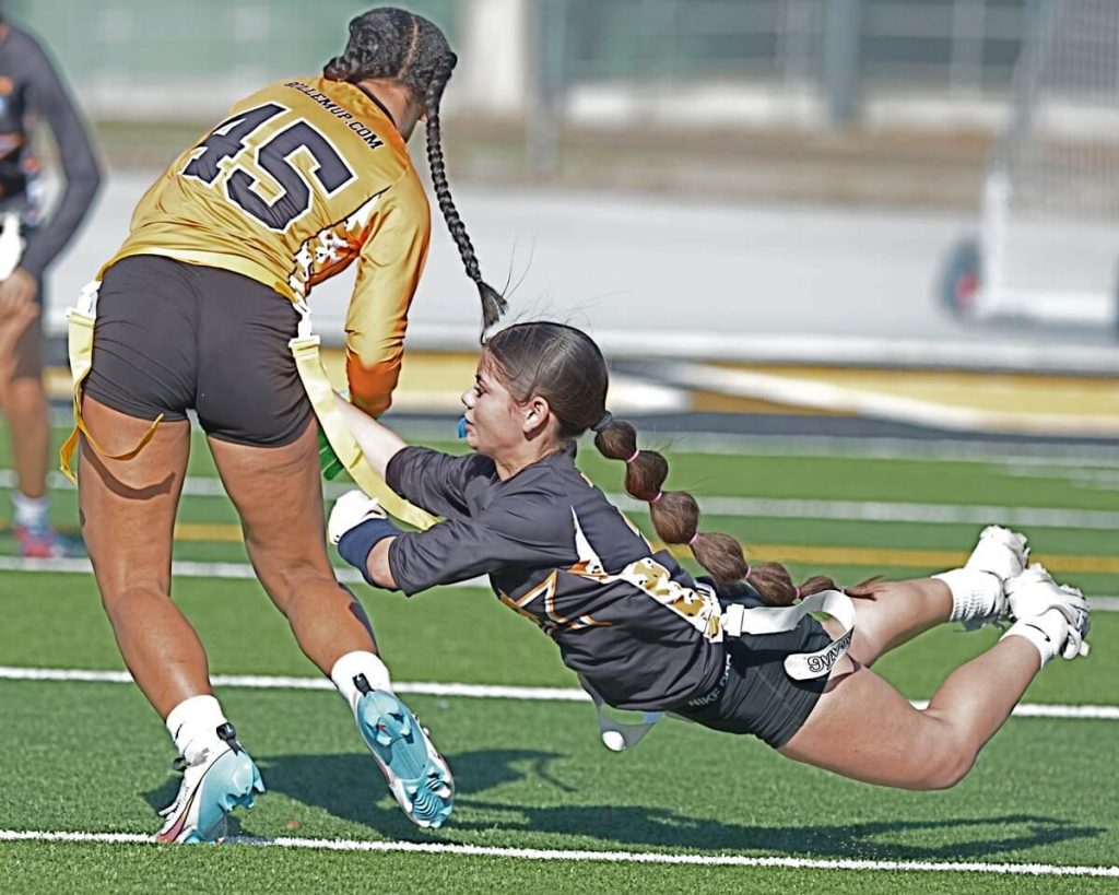 Team Stars defender Vyanca Clark, of Norco, dives to grab the flag of Team Bolts, Jasmin Campos, of Riverside Ramona. The first regional flag football all-star game, combined star athletes from Riverside and San Bernardino Counties, splitting them into non-county specific squads, Team Bolts and Team All-Stars. Team Bolts prevailed, 20-14