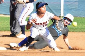 Norco’s Tamryn Shorter steals 2nd base ahead of Eastvale Roosevelt’s Lotoleilei Sivas (12) receiving the throw. The Cougars defeated the Mustangs 4 – 3. Credit: Photo by Gary Evans