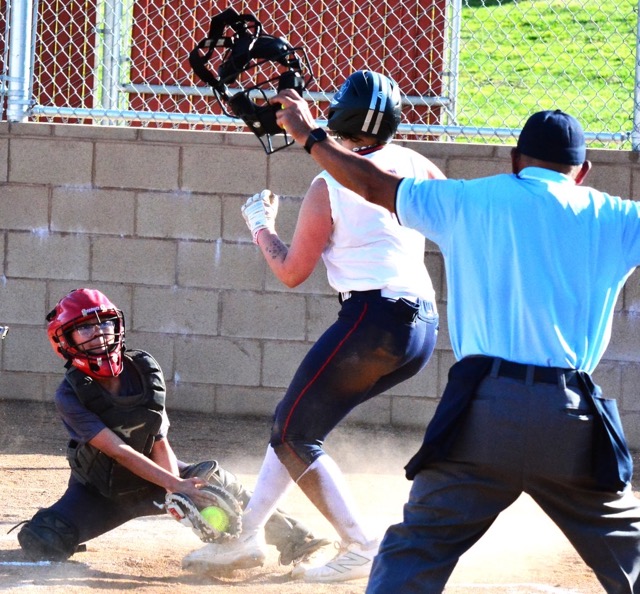Corona catcher Francesca Tapia (left) appears to apply the tag before Heritage’s Emma Sartori (15) touches the plate, but the call is “safe” during the first inning of play.  The Patriots defeated the Panthers.