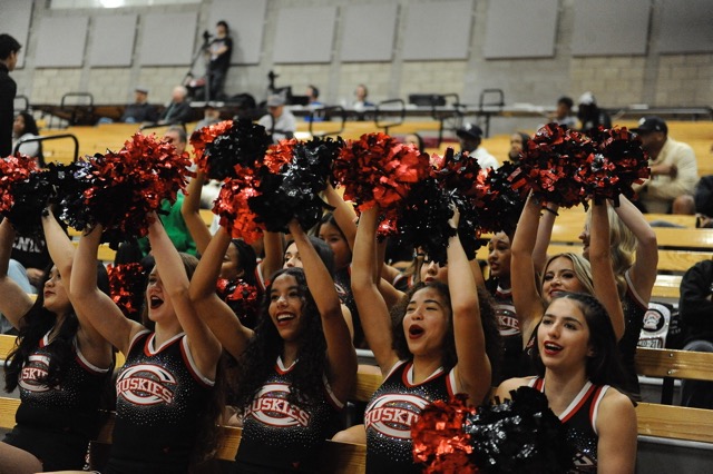 Corona Centennial cheerleaders try to keep the players’ spirits up during the 86-52 loss at Santa Ana Mater Dei in the CIF State regional tournament Thursday.