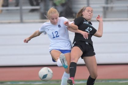 Santa Margarita's Ireland Regan beats Santiago's Abby Kelly for the goal that gave the Eagles a 1-0 lead on the way to a win on penalty kicks in the CIF Southern California regional final Saturday.