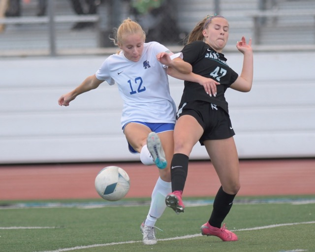 Santa Margarita's Ireland Regan beats Santiago's Abby Kelly for the goal that gave the Eagles a 1-0 lead on the way to a win on penalty kicks in the CIF Southern California regional final Saturday.