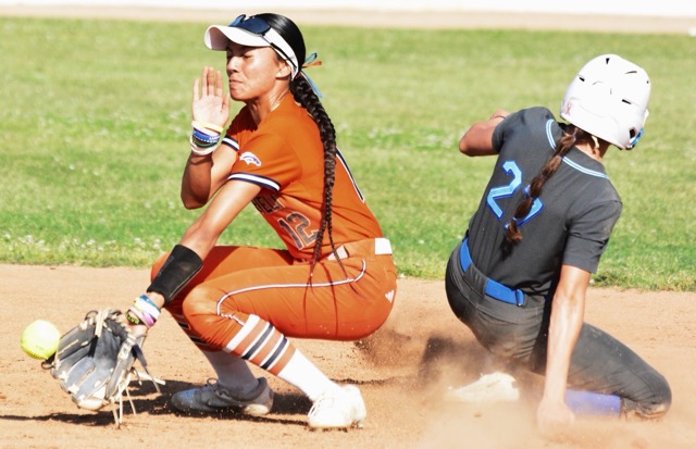 Norco’s Kayley Cook (27) steals second ahead of the throw to Eastvale Roosevelt’s Lotolelei Sivas (12) The Cougars outlasted the Mustangs 7 – 6 in 8 innings.
Credit: Photo by Gary Evans
