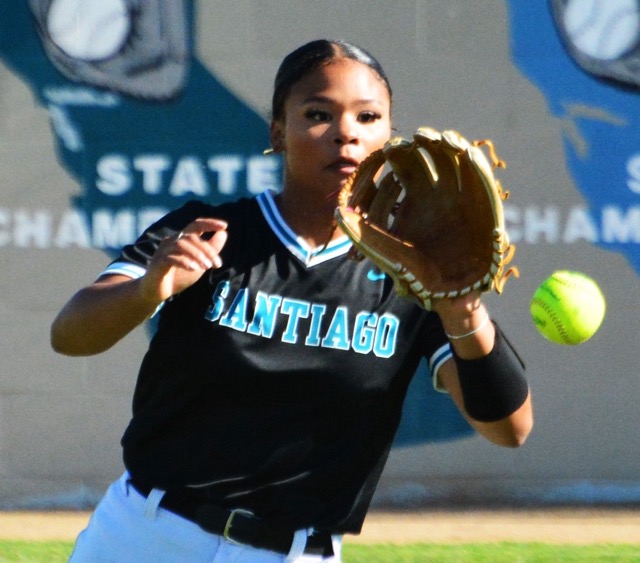 Corona Santiago’s Ashleigh Mejia fields a single to center by Norco’s Kaley Cook during the Cougars 16 – 0 thrashing of the Sharks. Credit: Photo by Gary Evans