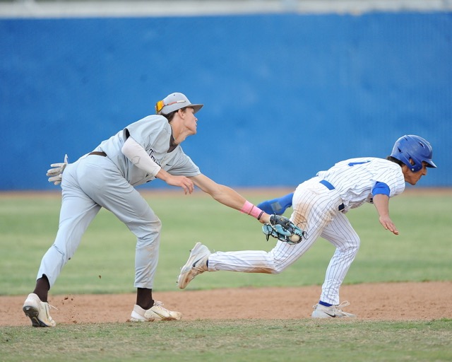 Featured Photos 4-12-2024 - Sports Photos and Scoreboard. Temecula Valley's Taden Krogsgaard tags out Norco's Robert De La Torre in a rundown between second base and third in a Darryl Kile Tournament game Friday. Norco won, 5-3. Photo by Jerry Soifer