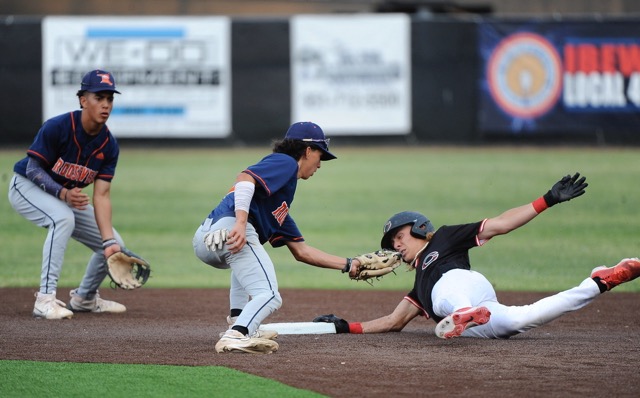 Corona Centennial's Aiden Simpson is safe at second base Friday as Eastvale Eleanor Roosevelt's Ethan Bush and Sam Fotinos can't make the play to tag Simpson out. Centennial won, 6-0.
Credit: Photo by Jerry Soifer
