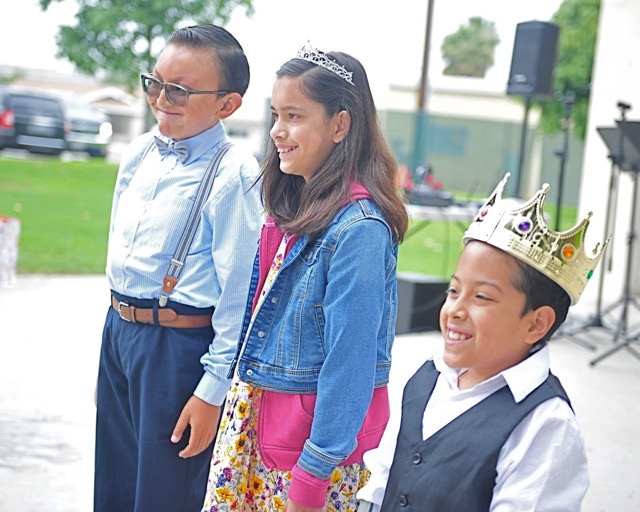 The Day of the Child was celebrated Saturday at Corona City Park with Oliva Morales, 11, center, and Brayan Ibarra Flores, 9, right, being crowned princess and prince by last year's prince Jaiden Cortes, left. The Day of the Child honors children coping with medical challenges. Olivia, a fifth grader at Eisenhower Elementary School in Corona was born six months prematurely at one pound one ounce. She has undergone corrective surgeries for breathing difficulties, vision problems, and a speech impediment. Brayan, a third-grade student at Corona Ranch Elementary was born with spina bifida, a birth defect in which the spine is not fully enclosed. 
Credit: Photo by Jerry Soifer
