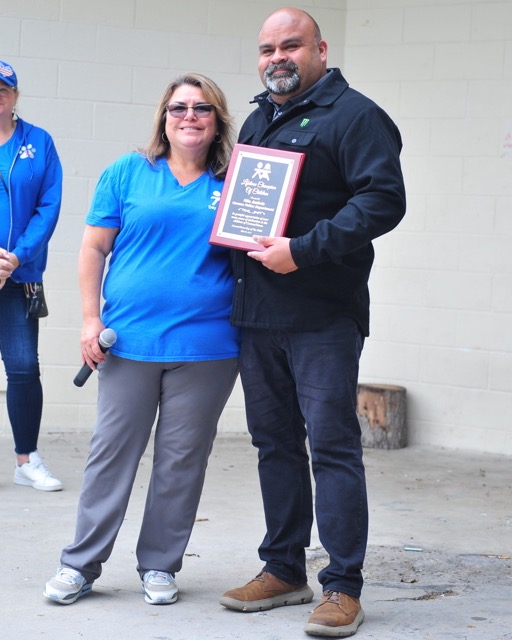 Retired Corona police officer Nilo Ambriz was honored Saturday for his work with children at the Corona Day of the Child event at Corona City Park. He holds a plaque presented him by Day of the Child chairwoman Sofia Betancourt.
Credit: Photo by Jerry Soifer

