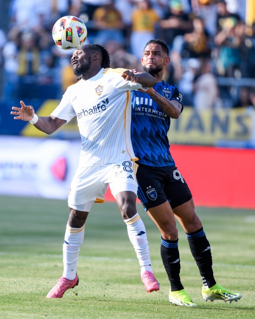 LA Galaxy midfielder Marky Delgado heads the ball while being covered by San Jose Earthquakes Amahl Pellegrino in an MLS game won by the Galaxy, 4-3, at the Dignity Health Sports Park.
Credit: Photo by Jerry Soifer
