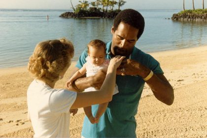OJ Simpson. Photo taken February 1986 at the Kahala Hilton Hotel in Honolulu Hawaii - This is my sister Jan, who asked for a photo with O.J. - O.J. is holding his daughter Sydney. Nicole Brown Simpson was with O.J. at this moment but out of camera range. She watching from behind camera. photo by Alan Light
