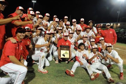 The Corona baseball team poses with the championship plaque it won at the CIF Div. 1 title game, 5-0, Saturday at the Lake Elsinore Storm Diamond.