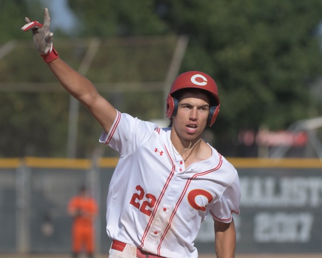 Corona’s Seth Hernandez signals home run as he circles the bases with his game-winning two-run blast that defeated visiting Huntington Beach in the CIF Div.1 semifinal game, 3-1, Tuesday.