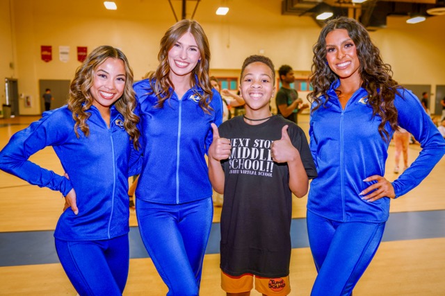 LA Rams Cheerleaders embrace MVS student Tyion Freeman