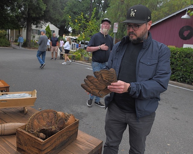 Thousands attended the Corona Heritage Park Antiques & Collectibles Faire on Saturday. Gilbert Elias holds vintage baseball gloves that were on sale.
Credit: Photo by Jerry Soifer
