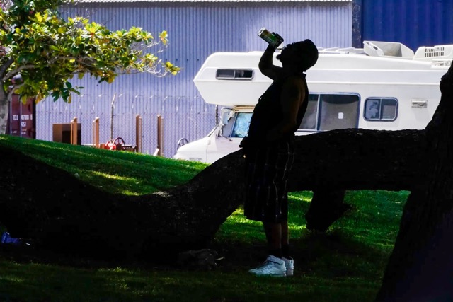 The Cost of Extreme Heat. A man drinks water during a heat wave in Los Angeles on July 13, 2023. Credit: Photo by Damian Dovarganes via AP