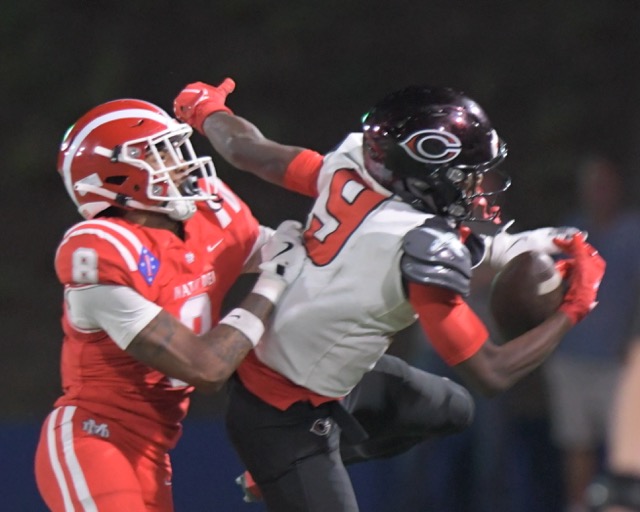 Corona Centennial's Tavian McNair makes a one-handed catch in front of Mater Dei's Darius Dixson in second half of non-league game at Santa Ana Bowl Thursday. Photo by Jerry Soifer