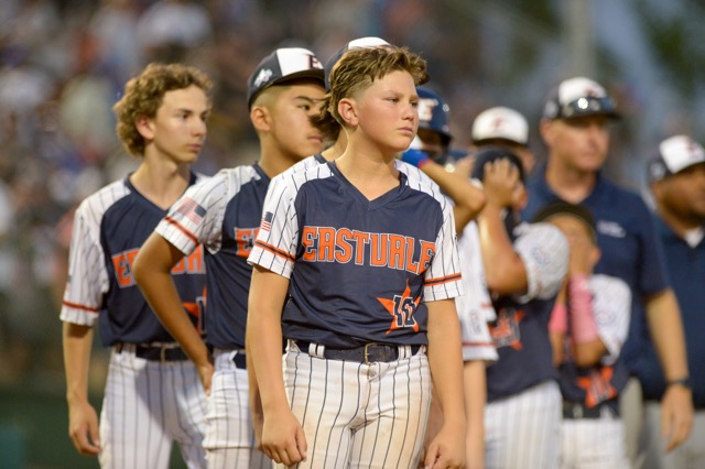 The Eastvale Little League All-Stars, with Grady Gentner (#10 center), are dejected after they lost, 2-1, to Maui Central East, Wailuku, Hawai'i in the Regional final in front of 12,000 fans at the West Regional Stadium in San Bernardino.