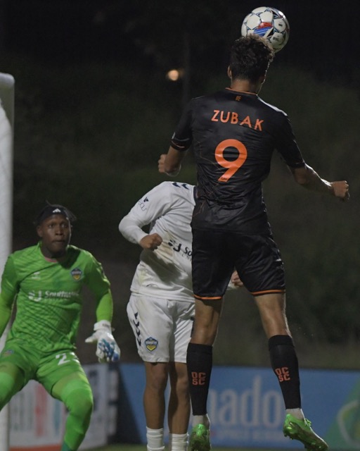 Corona Santiago grad Ethan Zuback, a forward for the Orange County Soccer Club, shoots a header against visiting El Pl Paso in a USL game at Great Park in Irvine but the ball flew over the net. El Paso won, 1-0.