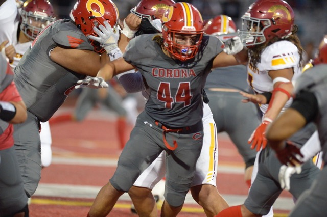 Corona's Jonathan Edgerton looks to make a block against Riverside Hillcrest Friday. 
Credit: Photo by Jerry Soifer
