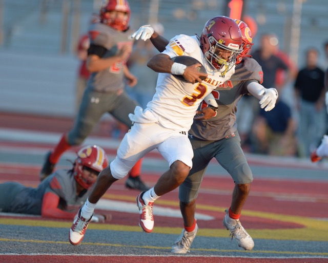 Featured Sports Photos 8-30-24. Hillcrest's Julian Sandoval breaks free from Corona defenders Friday in the non-league season kickoff game. The Trojans ran away with a 47-14 win. Credit: Photo by Jerry Soifer