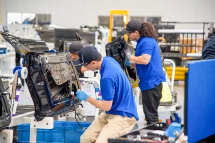 Workers build doors at the sub-assembly section of the Karma Innovation and Customization Center in Moreno Valley. Credit: Photo courtesy of the Karma Innovation and Customization Center