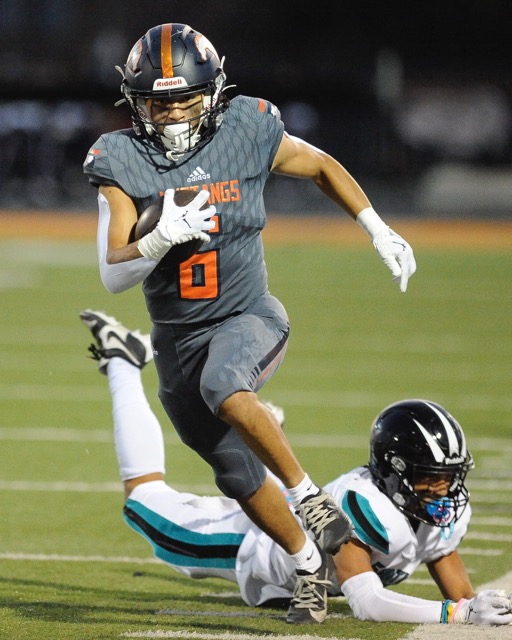 Eastvale Rosevelt's Noah Vasquez runs by Corona Santiago's Devin Wang for a touchdown in a Big VIII League game Friday at Roosevelt. Roosevelt won, 48-21. Credit: Photo by Jerry Soifer