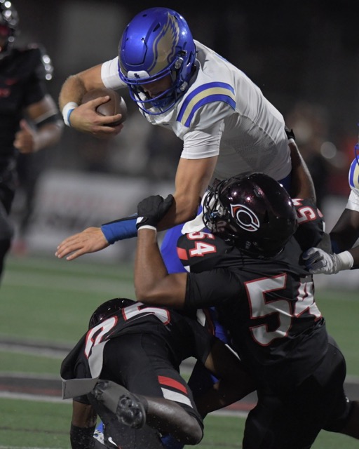 Santa Margarita quarterback John Gazzaniga goes up and over Corona Centennial in the first half of a non-league game at Centennial Aug 30. Santa Margarita upset the Huskies, 31-15.
Credit: Photo by Jerry Soifer
