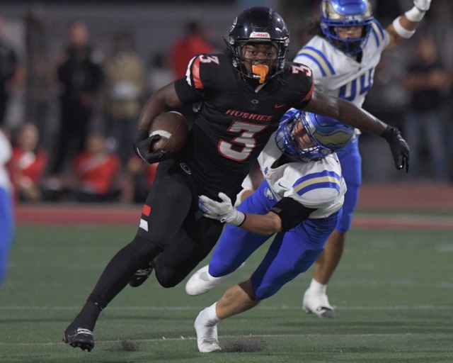 Corona Centennial running back Malachi Roby tries to break a tackle.
Credit: Photo by Jerry Soifer
