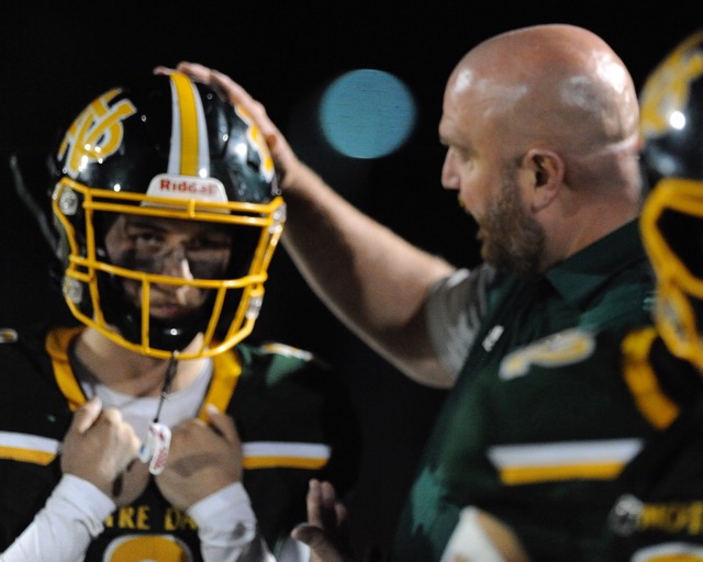 Riverside Notre Dame athletic director Rory Carlson comforts player Brent Owens on the sidelines during the first half.