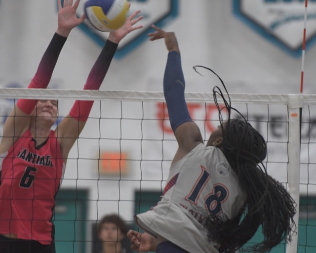 Corona Santiago's Fallyn Blotzer blocks a hit by Riverside King's Jael Moore in a Big VIII League game Tuesday. Santiago won, 3-0. Credot: Photo by Jerry Soifer