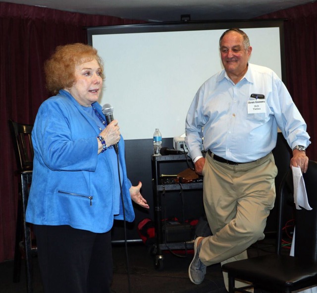 The late Linda Deutsch addresses a regular Newsgeezers luncheon as Bob Tarlau looks on. A veteran SoCal-based executive news producer since 1965, Tarlau co-founded the Newsgeezers in 2010, growing a roster of veteran Southern California TV, radio, print, web and PR journalists, that has had nearly 500 members. The organization is an avid supporter of the Eight Ball Emergency Fund, for journalists in need of temporary financial help. Tax-deductible donations can be made @ 8balljournalists.org.