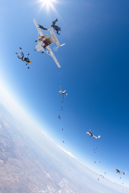 After jumping from 4 separate planes, the divers fly their way into formation Credit: Bruno Brokken