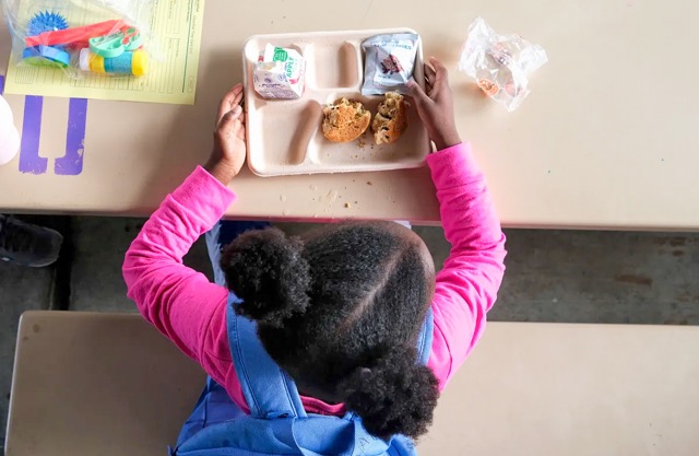 Food Dyes. A young girl sits down to eat free breakfast at Rosa Parks Elementary School in San Diego on June 14, 2024. San Diego Unified School District is partnering with local organizations to offer free meals to families and students during the summer. Credit: Photo by John Gastaldo for CalMatters