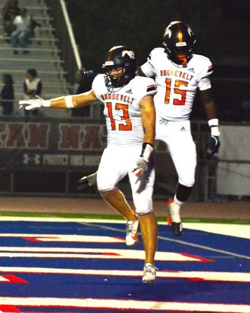 Eastvale Roosevelt’s Ty Beadle (13) and Dezman Howard (15) celebrate Beadle’s 20 yard fumble return for a touchdown after Ontario Colony. The Mustangs defeated the Titans 27 – 20.
Credit: Photo by Gary Evans
