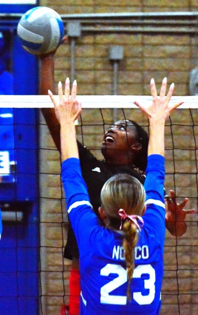 Centennial’s Lailah Thompson gets a shot over Norco’s Savannah Smith (23) during the Huskies 3 – 0 victory over the Cougars. Credit: Photo by Gary Evans