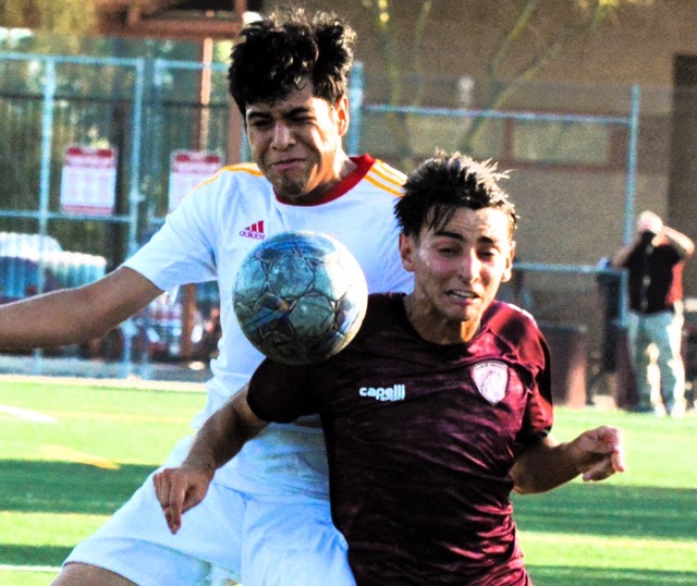 College of the Desert’s German Castro (left) and Norco’s Vinicus Gonclaves (right) collide while chasing down a pass during the first half of the Mustang match against the Road Runners. 
Credit: Photo by Gary Evans
