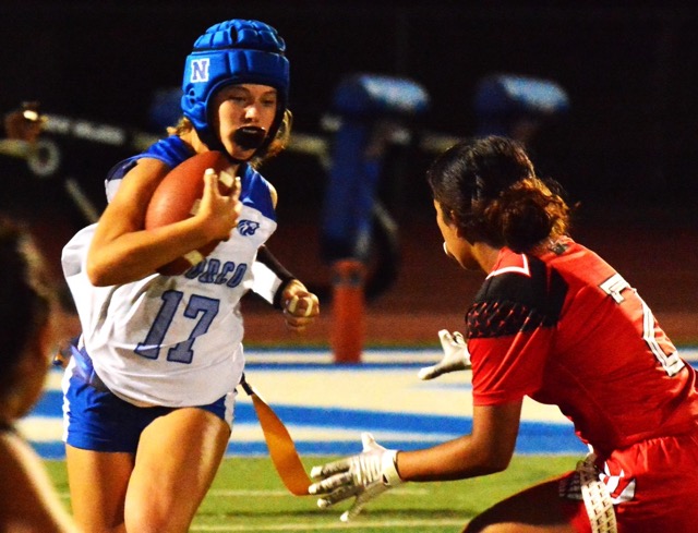 Norco’s Makynzie McDaniel’s (17) gains yardage before Etiwanda’s Karli Aguilar (2) can pull the flag.  The Cougars held off an Eagles rally to win 26 – 21. 
Credit: Photo by Gary Evans
