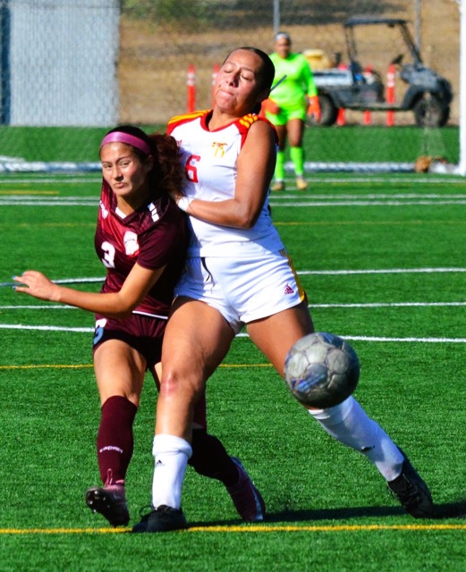 Norco College’s Carys Anderson (left) gets a shot on goal while College of the Desert’s Isabella Hernandez (6) tries to knock Anderson off balance.  The Road Runners defeated the Mustangs 4 – 1.  
Credit: Photo by Gary Evans
