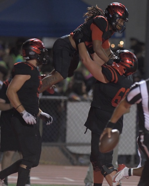 Murrieta Valley's Kurelle Thomas gets a lift from teammate Vince Guerrero after Thomas scored the clinching touchdown in the Nighthawk’s 35-25 victory over visiting San Clemente in a non-league game. Credit: Photo by Jerry Soifer