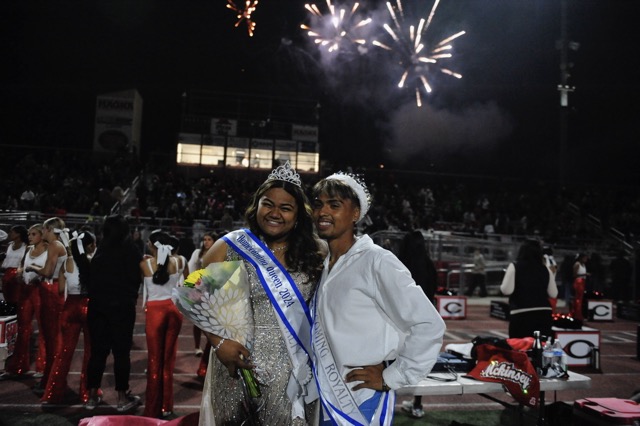 Fireworks form the backdrop as Centennial students celebrate the naming of Homecoming Queen Faoaaai Gatoloai and King Anthony Felix Friday at halftime of the game with visiting Murrieta Valley.