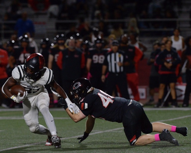 Murrieta Valley running back Jeremiah Watson 
eludes the attempted tackle by Corona Centennial defender Hayden Zentner. 
Credit: Photo by Jerry Soifer
