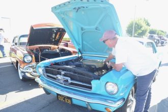 Steve Erwin, of Anaheim, employs the juice from his Chevrolet Bel Air to jump-start the 1964 Ford Mustang of his friend, Keith Otte, of Garden Grove. Last Saturdays car and bike show was the 8th Annual Boudreau Pipeline Charity Event in Corona, which raised $81,000 for two charities, Friends of Leaps and Bounds and the Autism Society of Inland Empire.